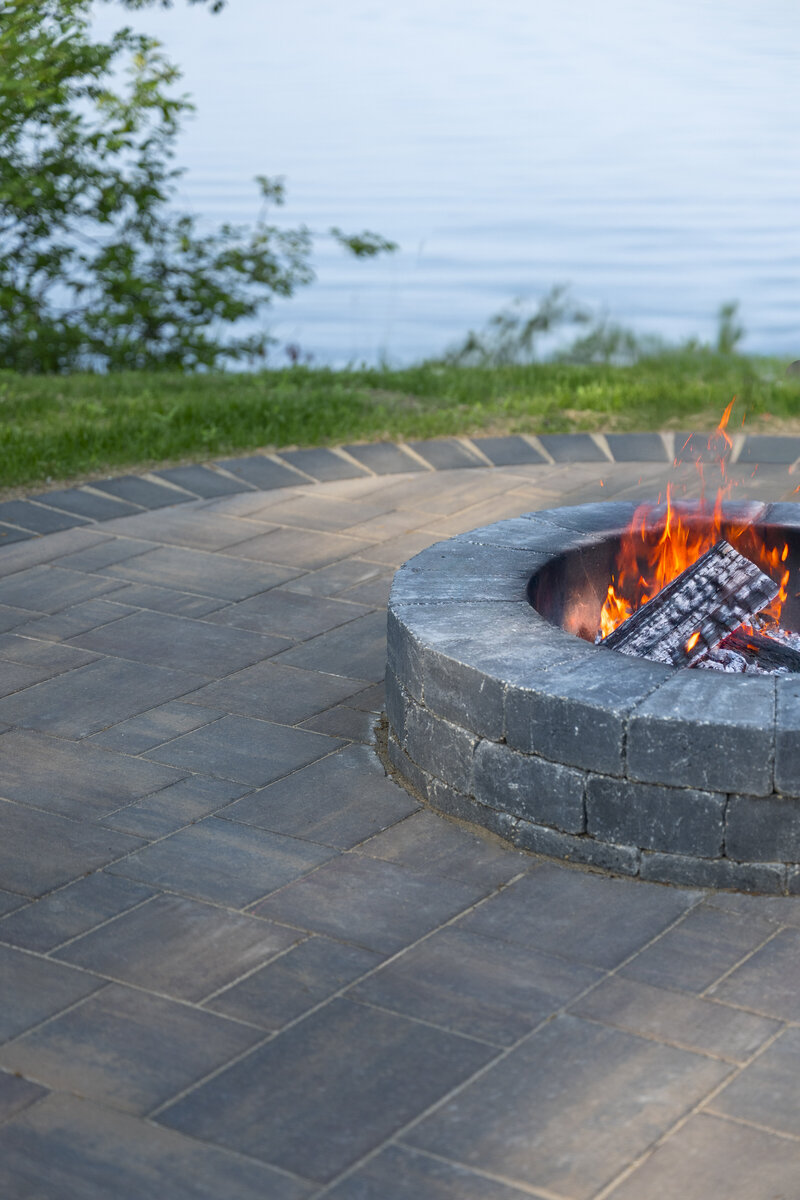 Bemidji home backyard entertaining patio with stone fire pit