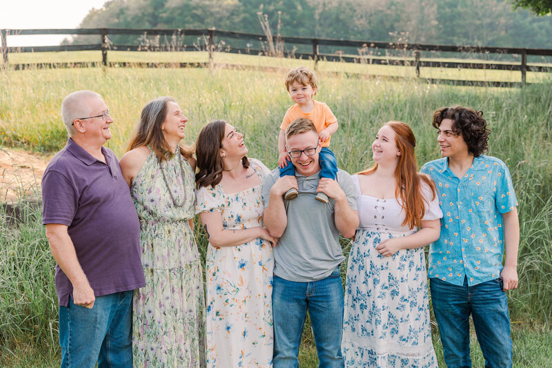 Family of five enjoying a relaxed outdoor session in Bridgewater, VA, capturing natural moments