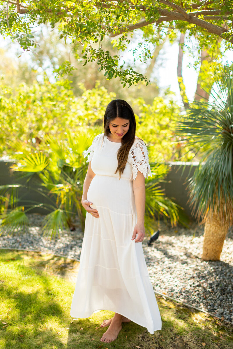 Maternity portraits of mom to be with a white dress at a private estate in Palm Springs, CA