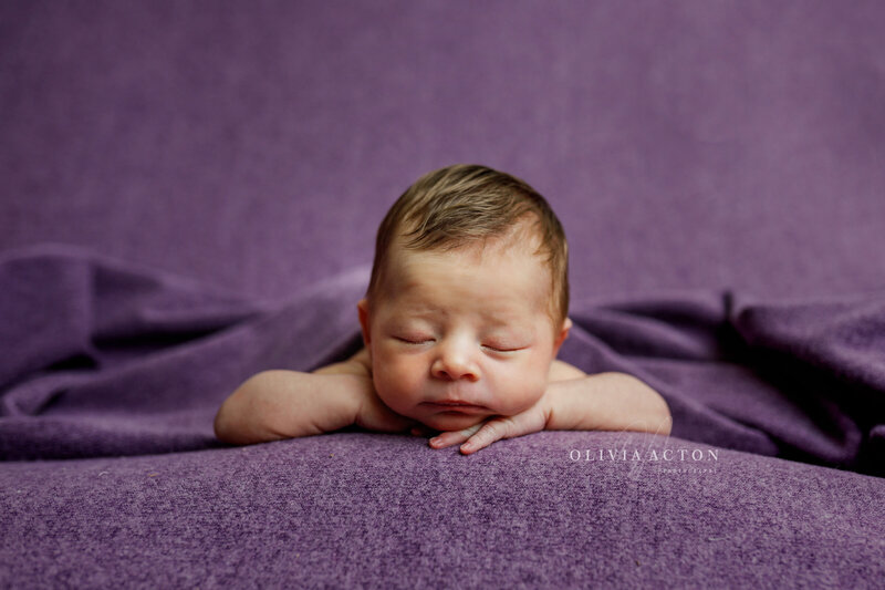 Newborn baby in purple by Olivia Acton Photography located in Janesville, WI
