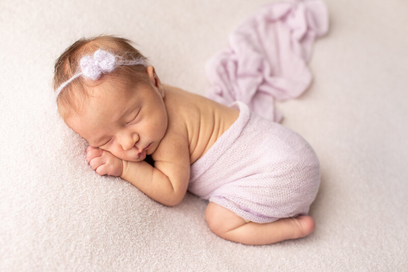 Baby girl sleeping wrapped in purple fabric by Maryland Maternity Photographer : Rebecca Leigh Photography