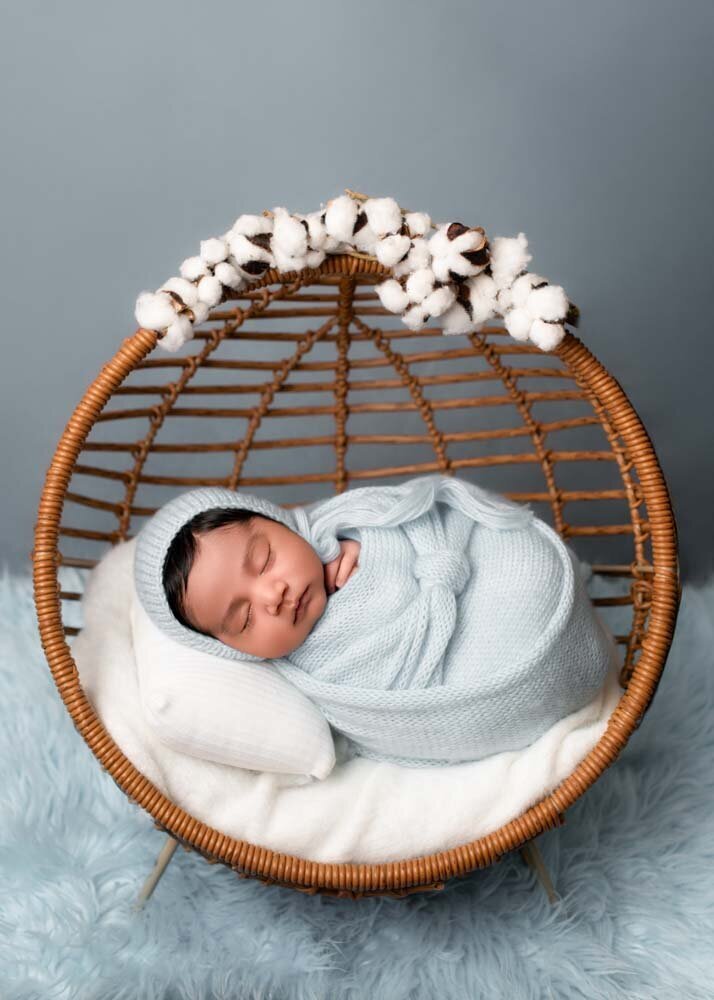 newborn-baby-blue-swaddle-in-hanging-chair-prop