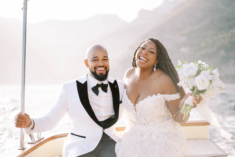 Positano wedding photographer bride and groom in boat smiling destination wedding photographer