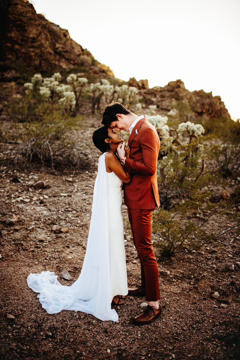 Bride and groom sweetly embracing each other