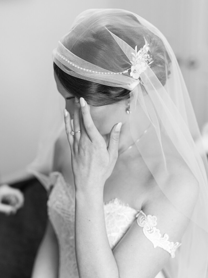 bride wiping tears away by wedding photographers baltimore Nicole Simensky