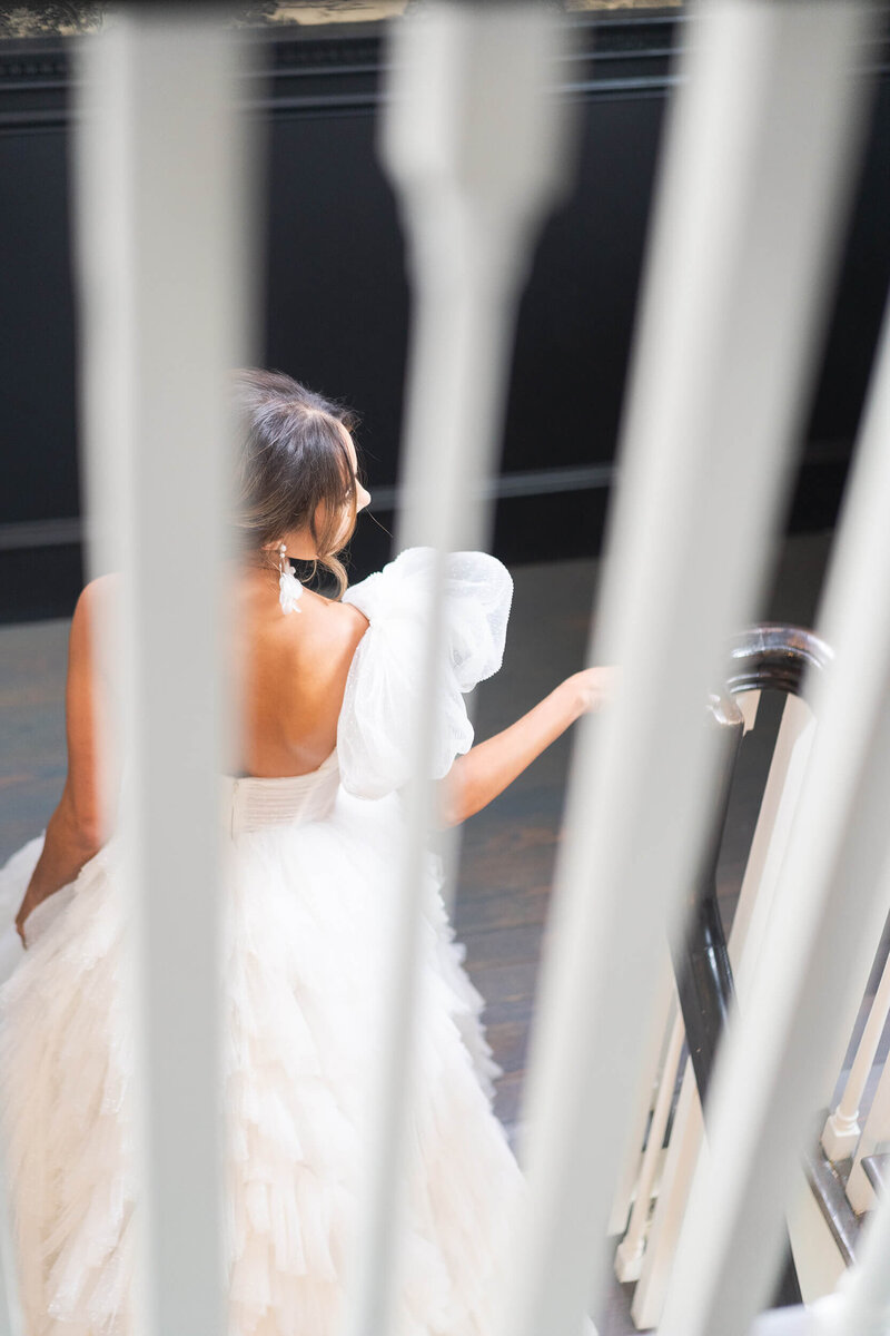 Houstons best wedding photographers Swish and Click Photography Houston bride walks up the stairs during her bridal session at The Mason