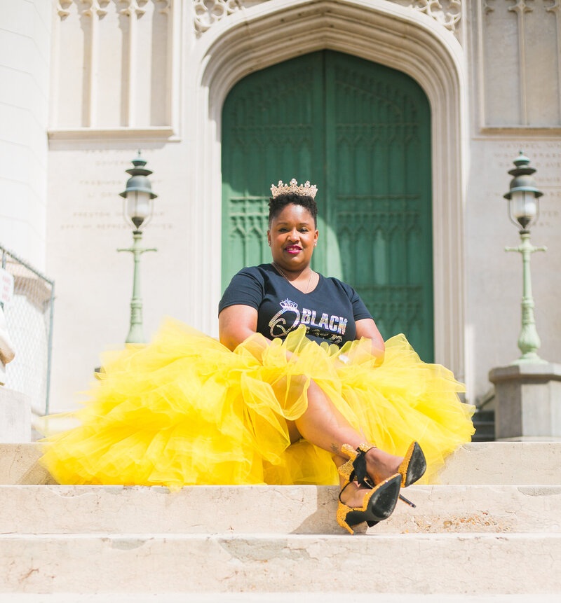 Woman with tiara in yellow tulle skirt and birthday shirt