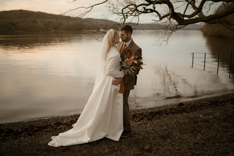 Couple portrait by the lake, captured at a Lake District wedding