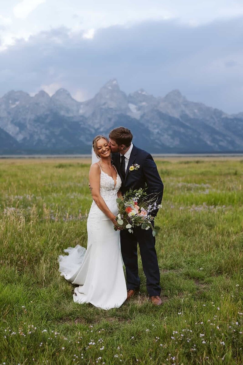 A couple looking into each others eyes laughing in the Sawtooth mountains in Stanley, Idaho