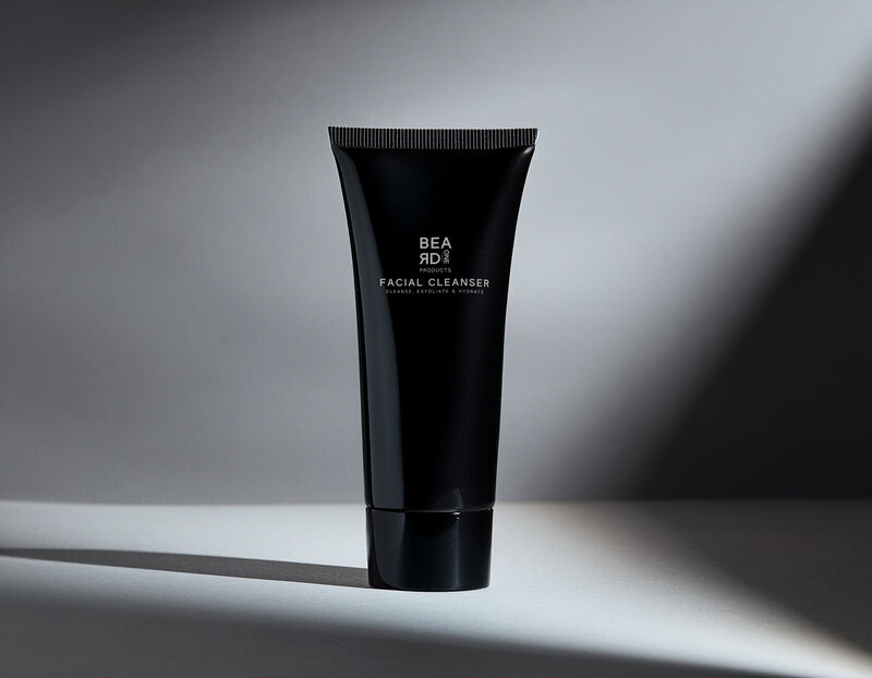 Beard One Products facial cleanser in a black tube on a gray background
