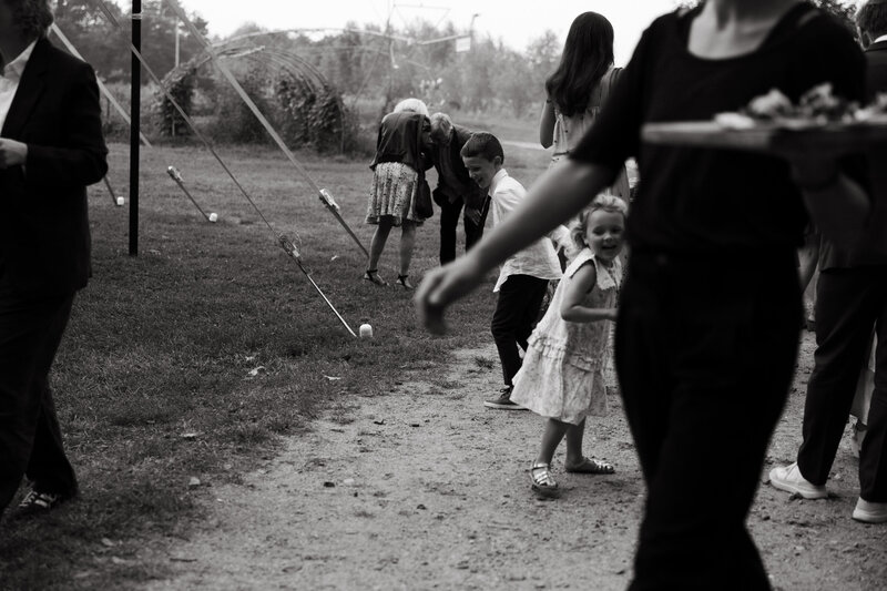 children playing at wedding reception at barn in new england