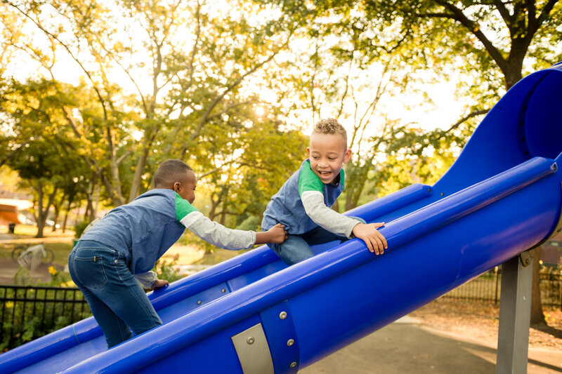 boys on a slide near Charles River