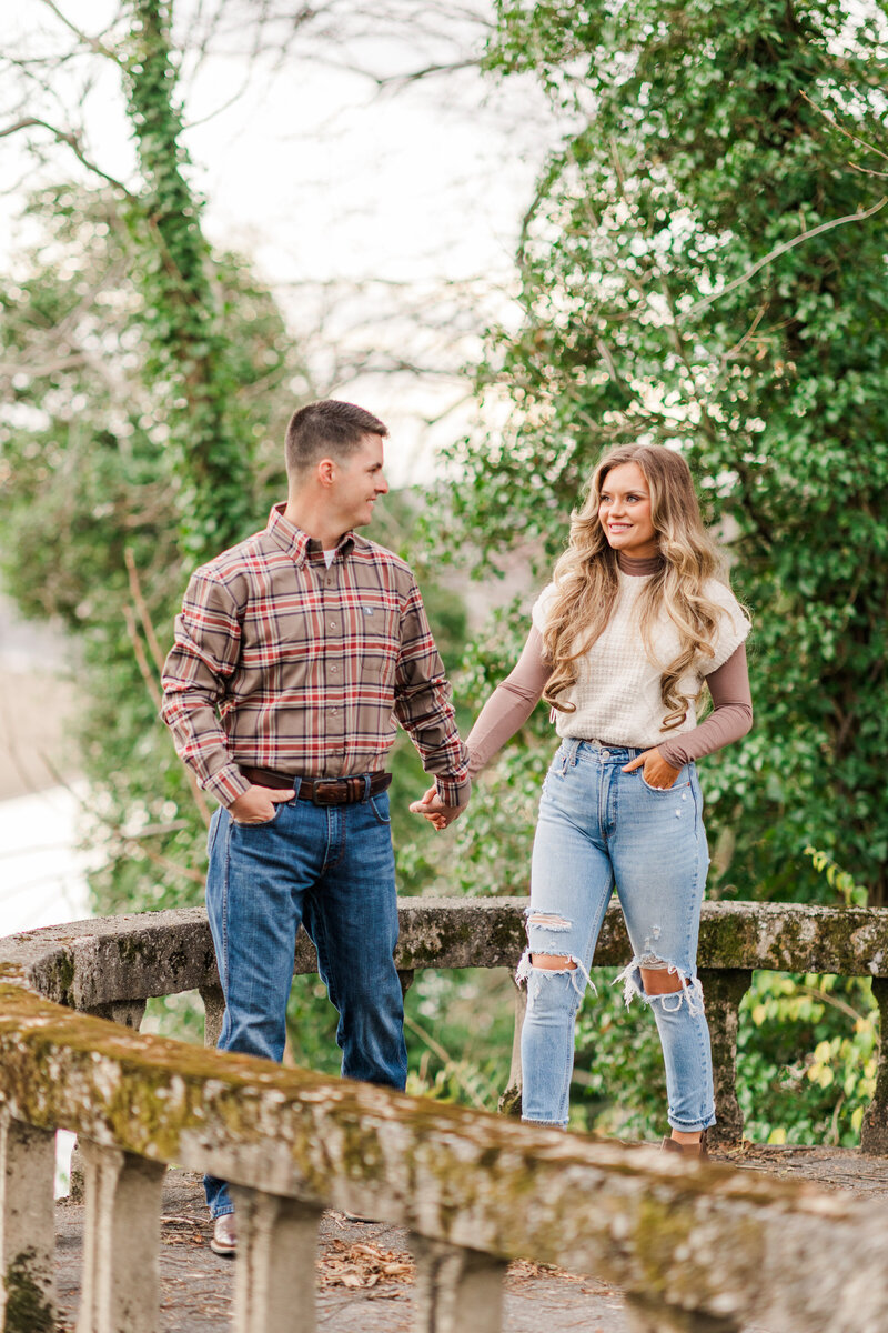 engaged couple holding hands while walking