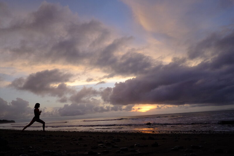 yoga student on costa rica beach at sunrise on new years
