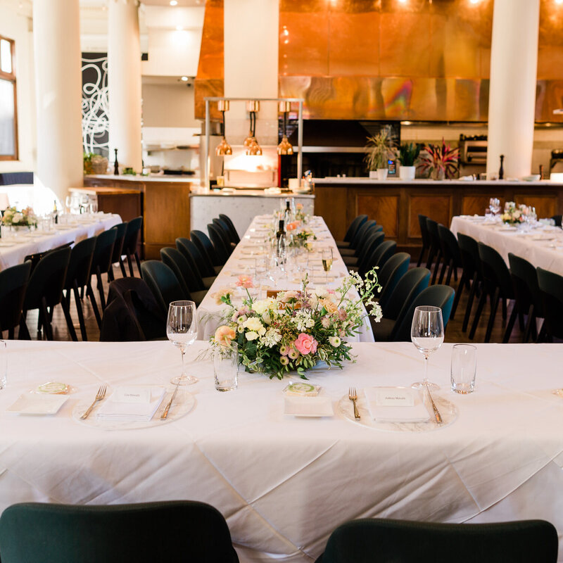 This elegant photograph captures a beautifully arranged wedding reception at Teatro Restaurant in downtown Calgary, showcasing the venue's sophisticated ambiance for a memorable celebration.