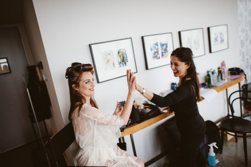 Bride giving her makeup artist a high five