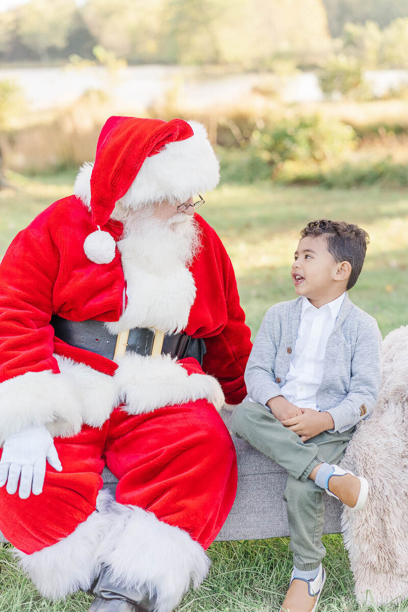 santa chatting with boy during Christmas minis in NoVa