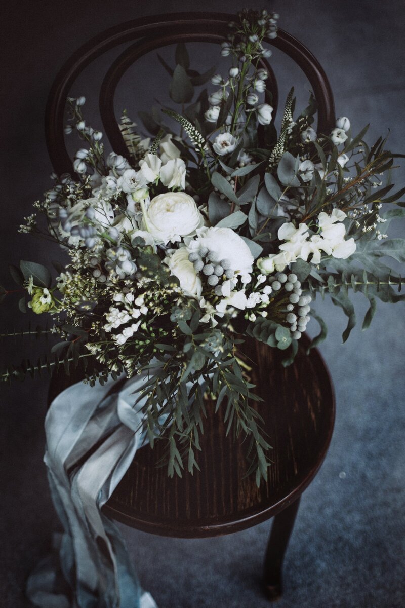 Blue and green bouquet on black chair