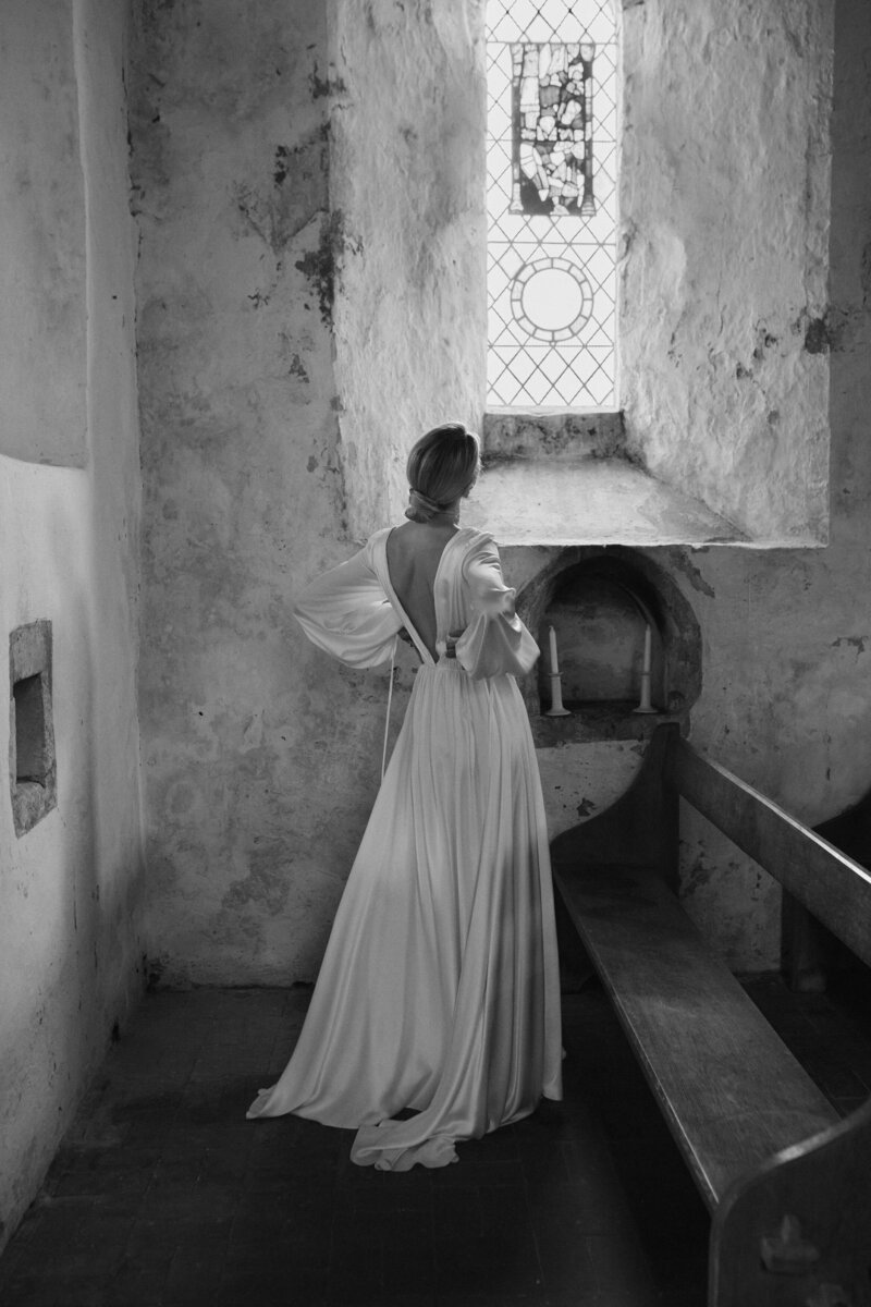 Deep v back modern silk wedding dress on natural bride in church