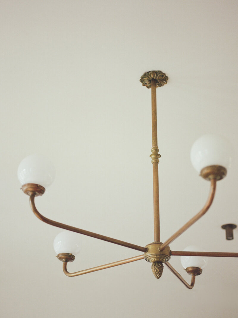 simple brass chandelier with modern lamps, clean details, interior design photography at ALEO Detroit