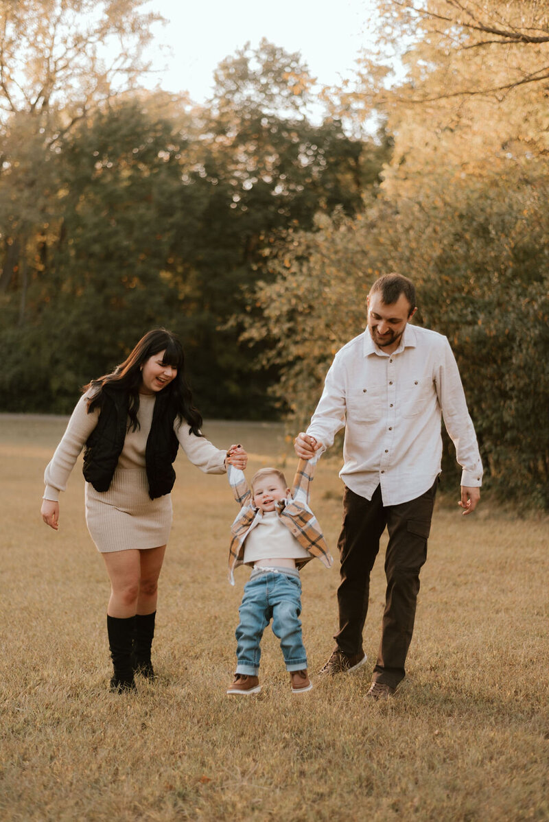 mom and dad hold son during family photos in peoria il