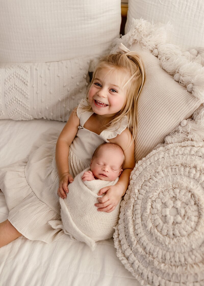 Newborn baby swaddled in neutral tones during a Denver studio photography session