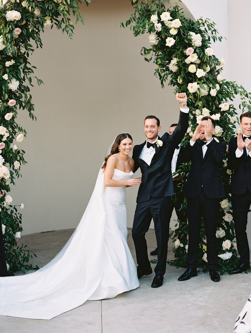 Flash film photo of a messy reception table with shoes on the ground