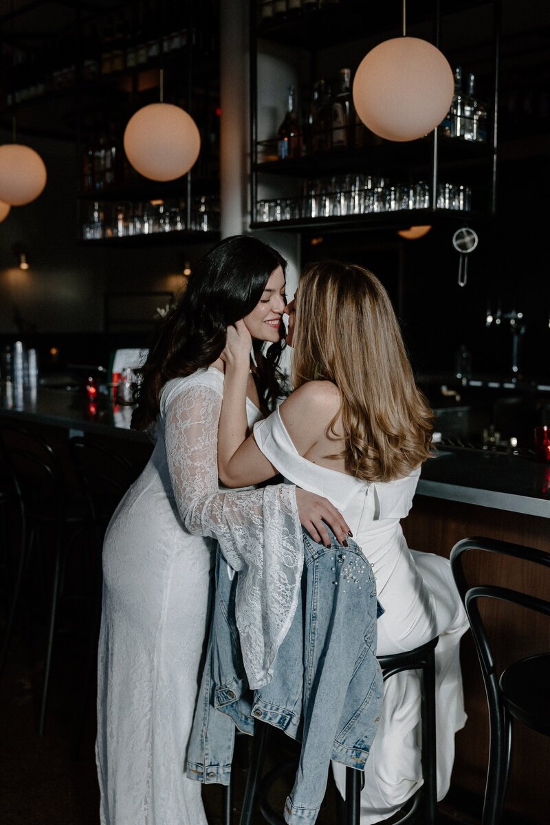brides kissing at bar in south boston