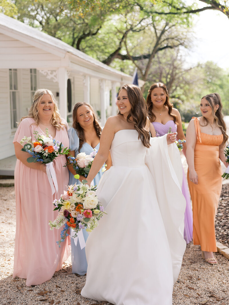 bridesmaids-walking-at-gruene-estate-texas