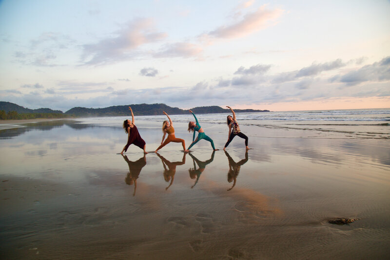Four students in Exalted Warrior Pose at Soma Yoga Institute's Costa Rica yoga teacher training