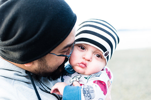 father nuzzling baby with striped hat and star wars pjs | Meg Sivakumar Photography