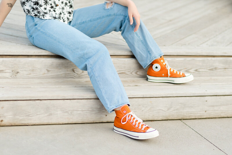 Color image of female with orange converse on