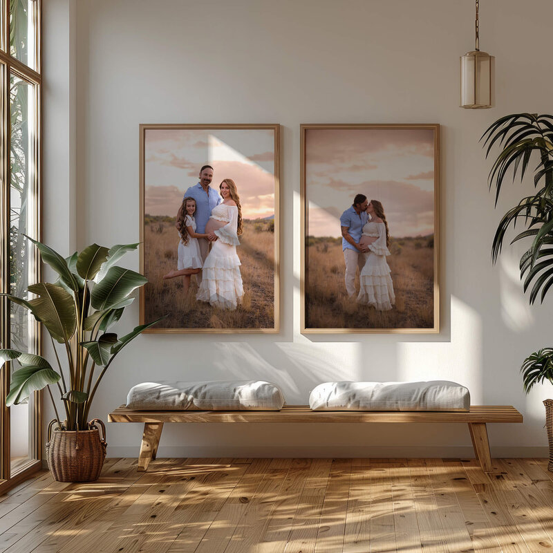 A hallway with a window to the left features two portraits on the wall by Brittany Danielle. They are family maternity portraits at sunset.
