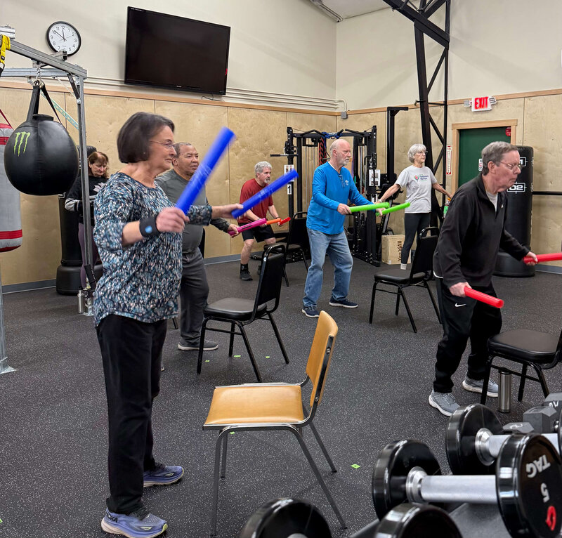 Parkinson's warriors follow along during an exercise class in the Parkinson's Warriors gym. 