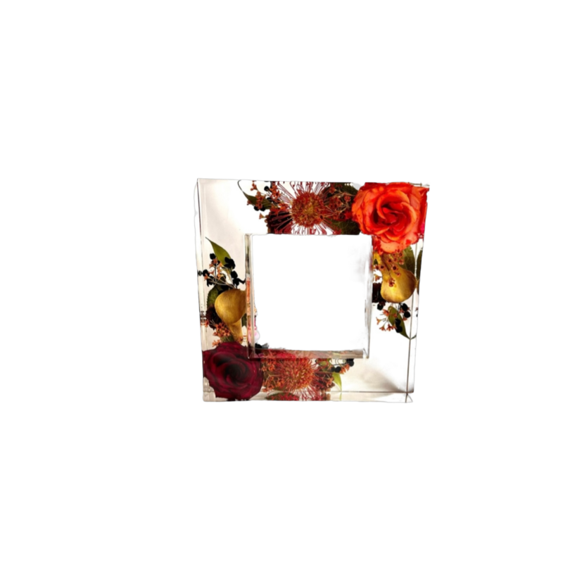 large resin frame with brides bright and colorful wedding flowers preserved inside