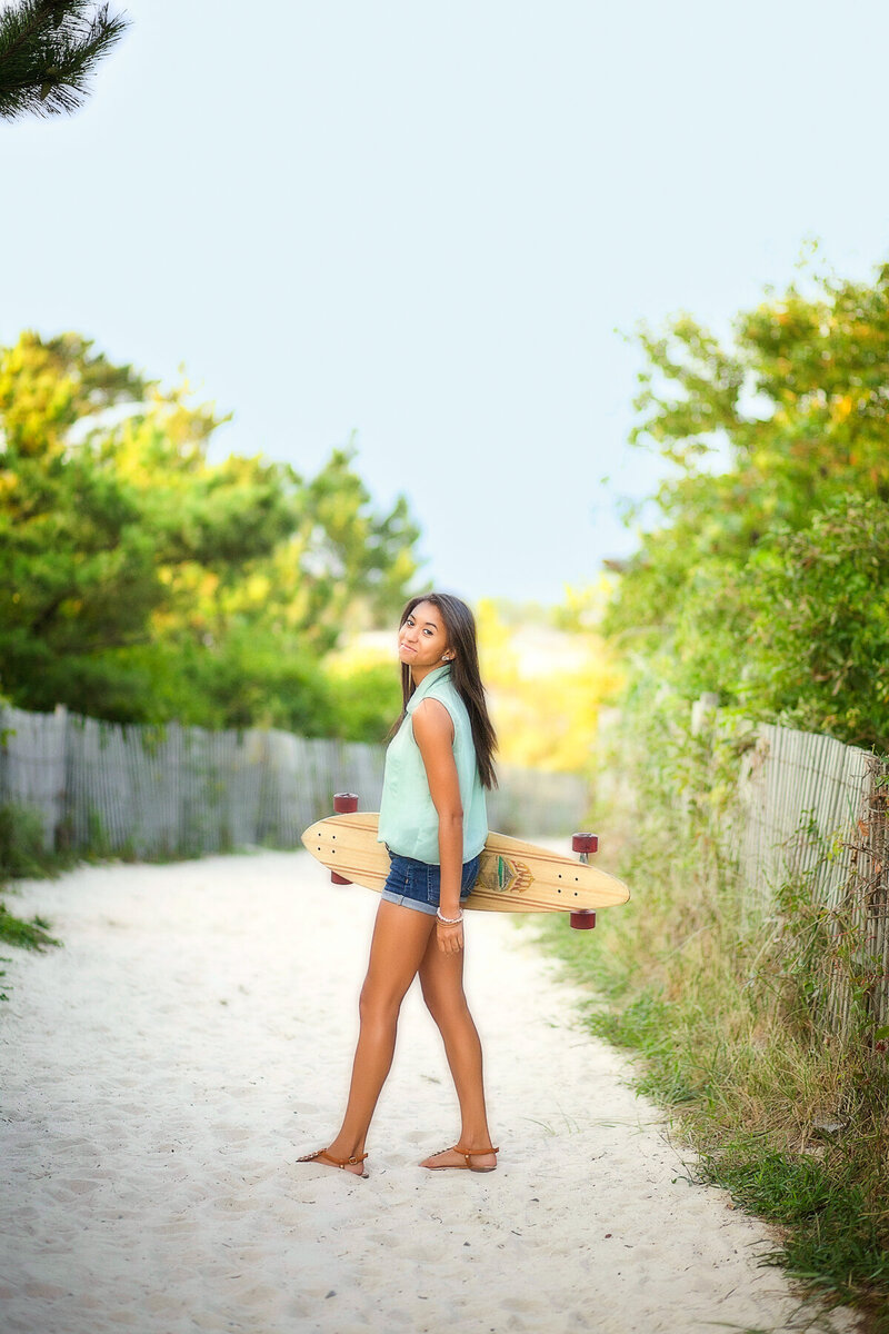 Girl on the beach with her longboard