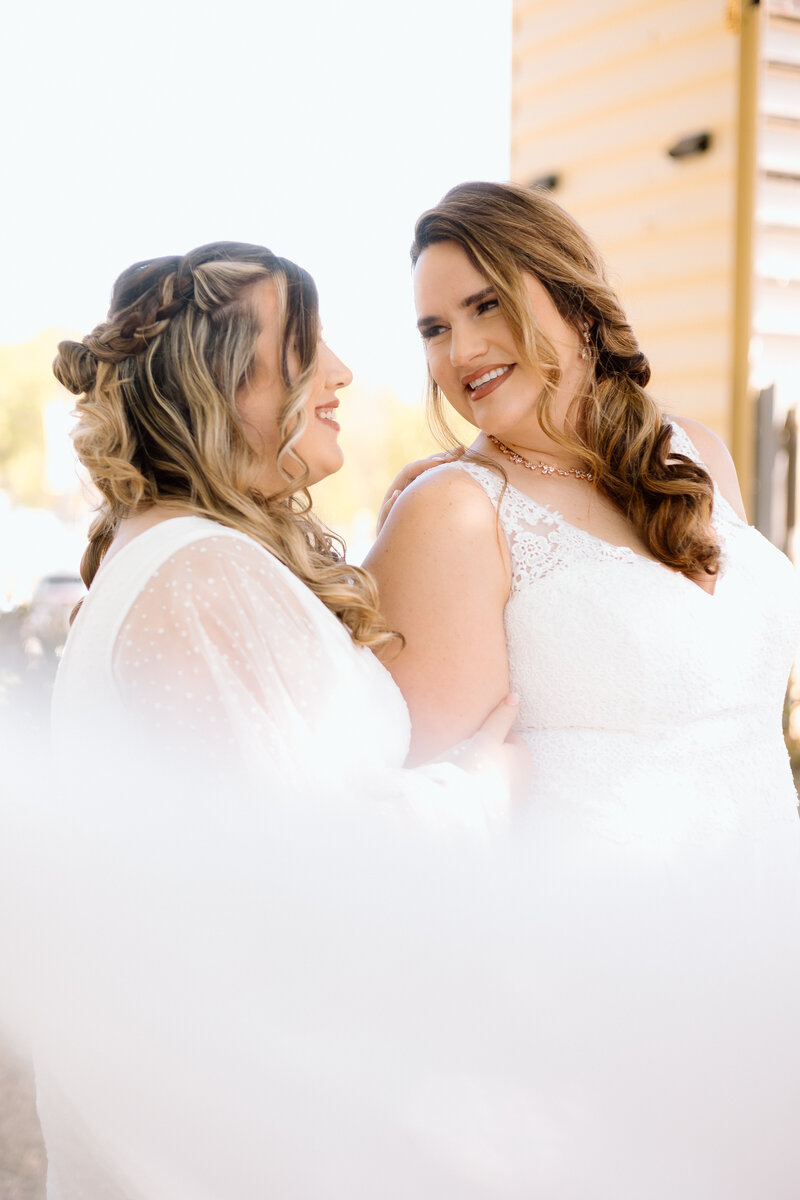 two brides looking at each other