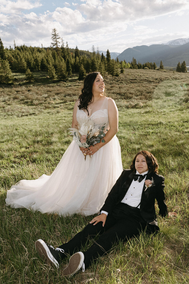 A couple standing on the side of Lake Dillon Reservior after their wedding