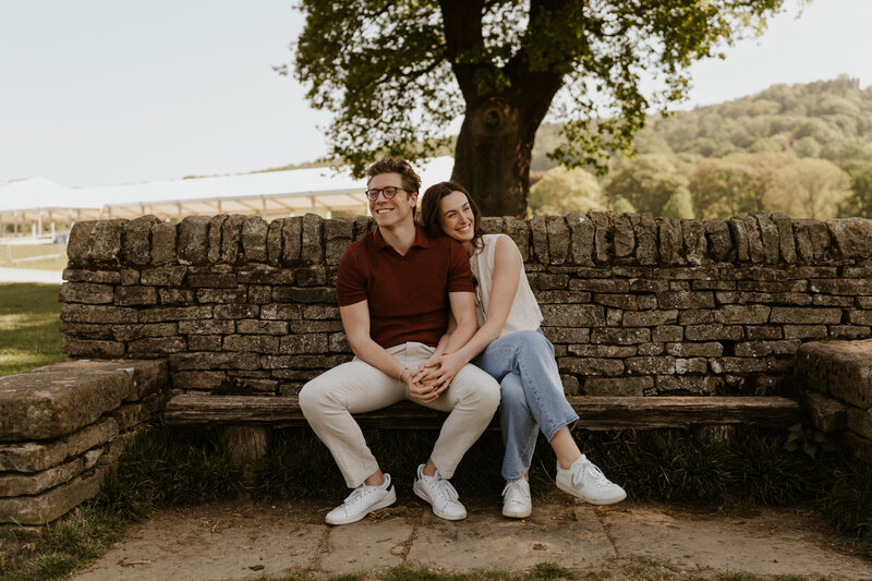 An adventurous couple embraces in the midst of a breathtaking natural landscape, celebrating their engagement