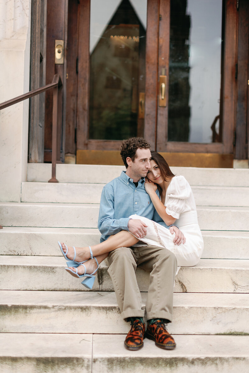 A couple embraces on the steps of the George Peabody Library before their wedding