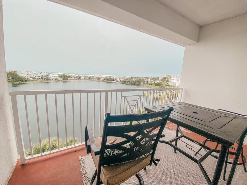 balcony overlooking lake with table and chairs