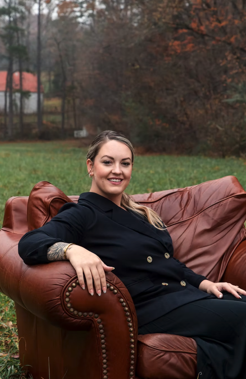 leather chair outdoors with woman sitting on it