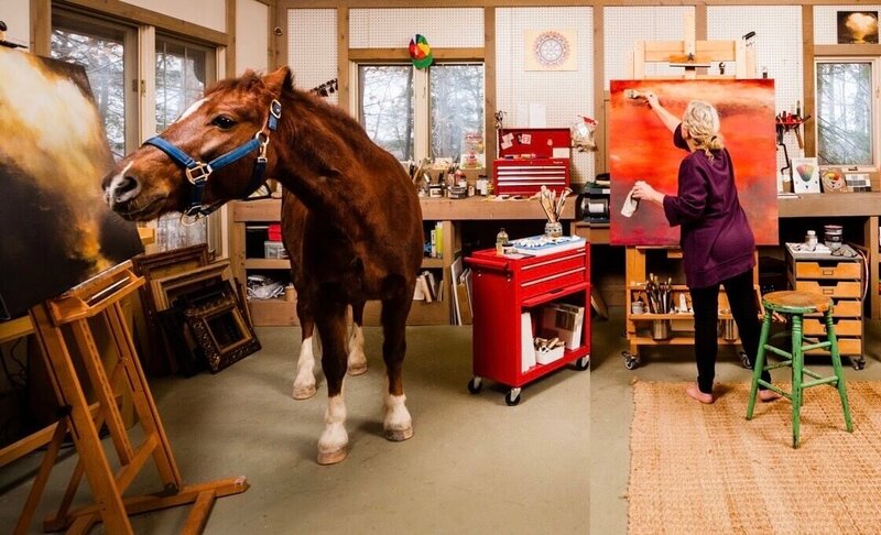 Jane Mishkind painting in her studio with her horse Justice inside