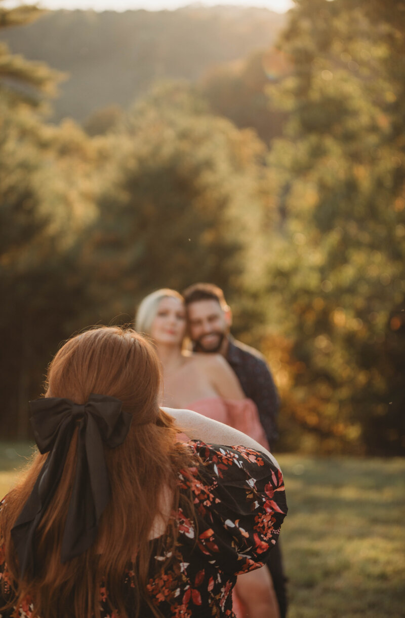 Melena Lawson with her camera capturing a couple in Athens, West Virginia