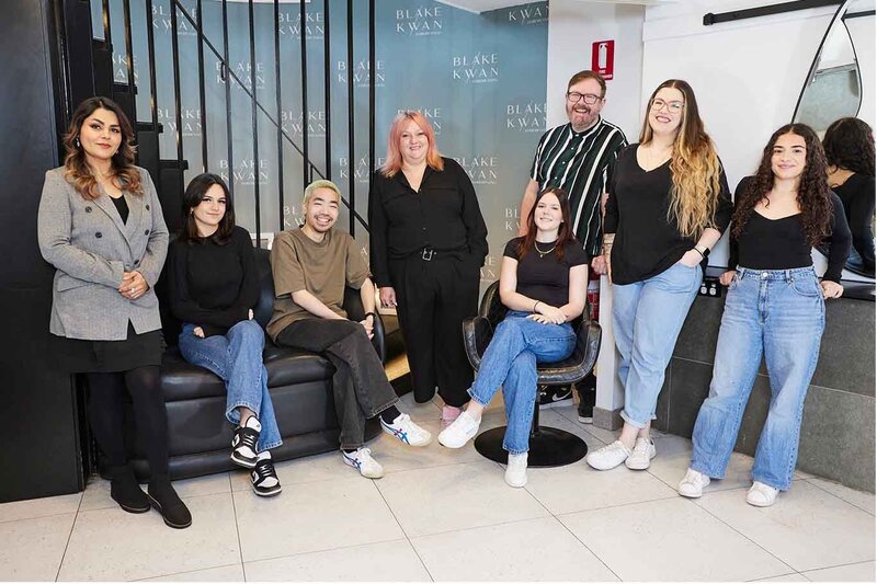 Team of hair specialists at Blake & Kwan Hairdressing in Sutherland Shire, posing in a modern salon with branded decor.