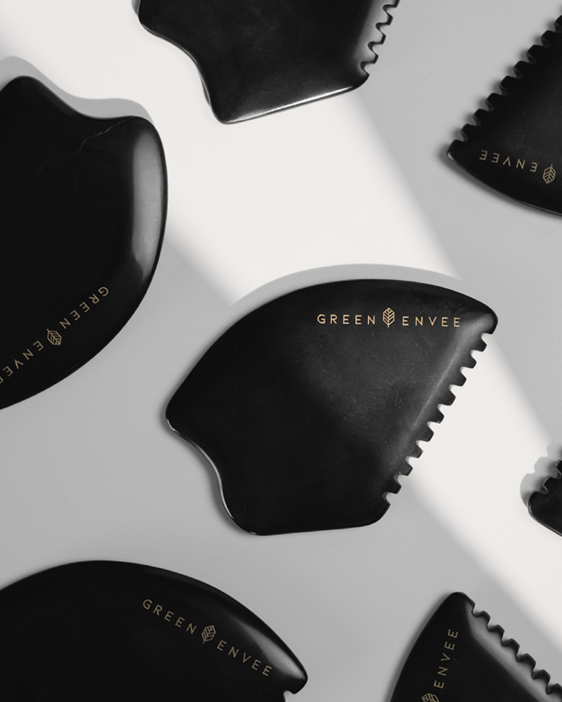 Photo of black jade stone Gua Sha used in facial treatments.