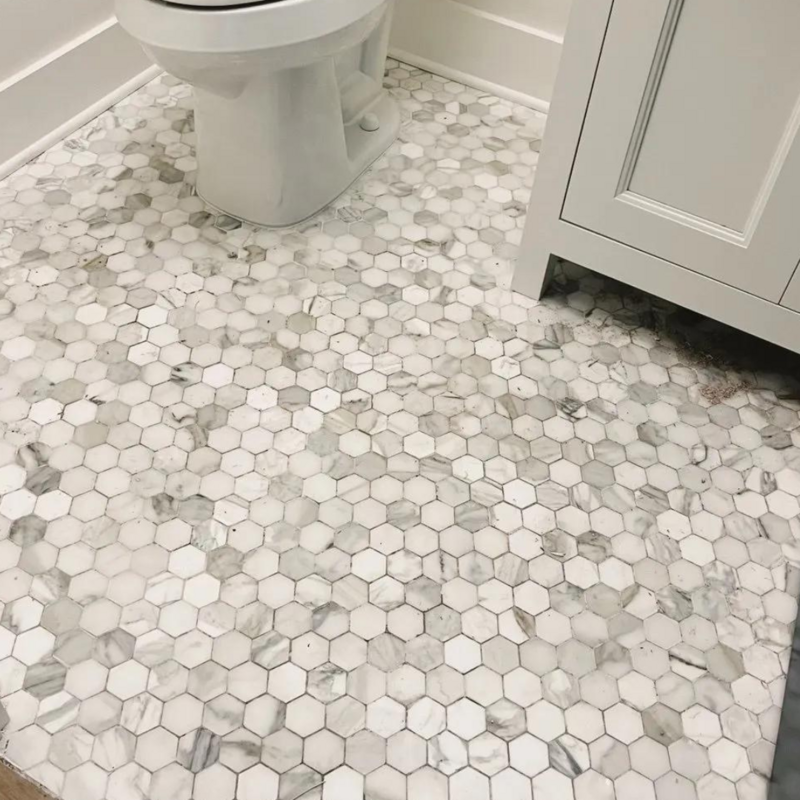 White and gray small hexagon tile in a bathroom