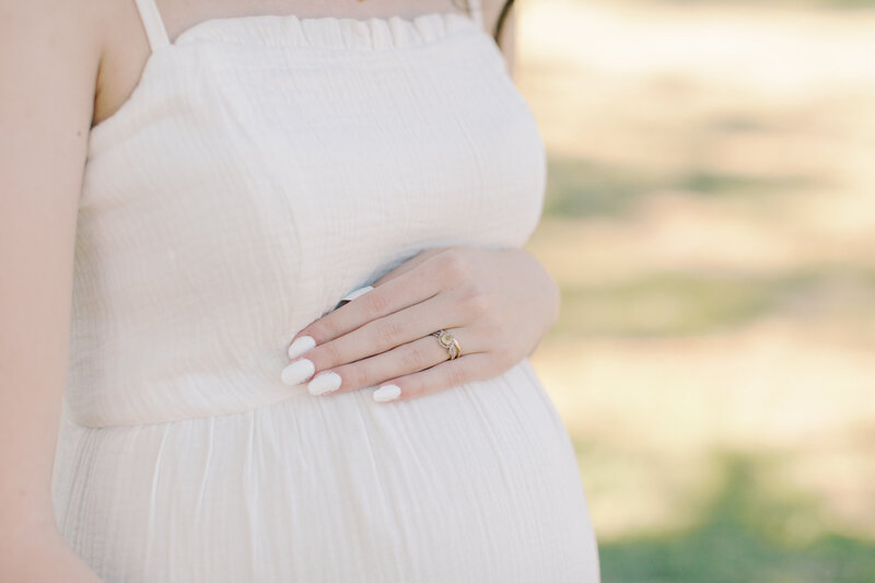 hands holding a baby bump