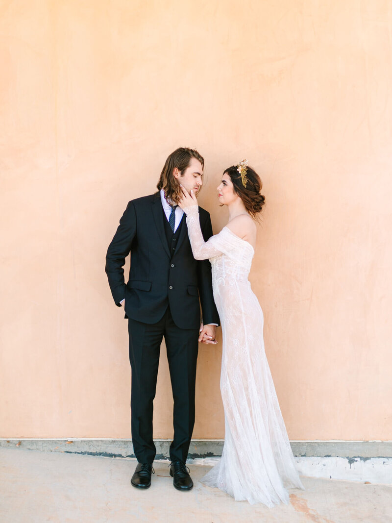 romantic pose of bride touching groom's face