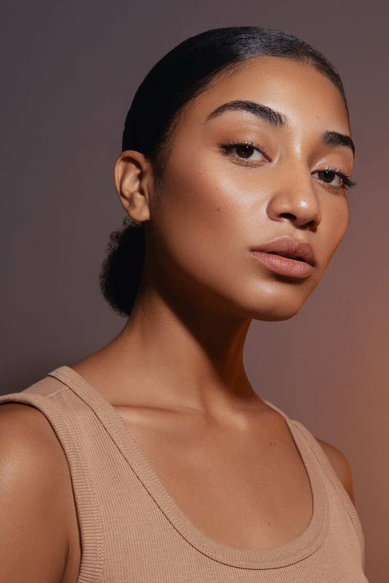 Tajah Moore in a serene close-up portrait, highlighting smooth skin and soft lighting, captured by Ylva Erevall.